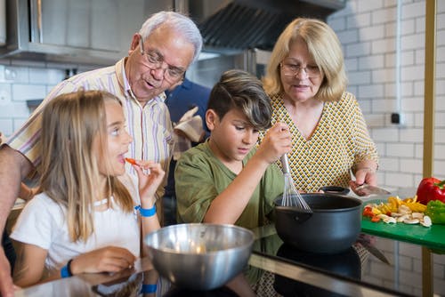 kids and grandparents cooking together