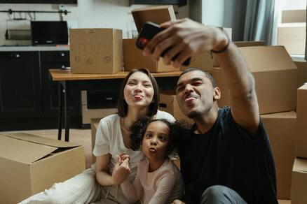 A family taking a funny selfie while packing